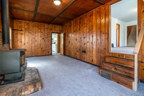 a view of a room with wooden walls and stairs