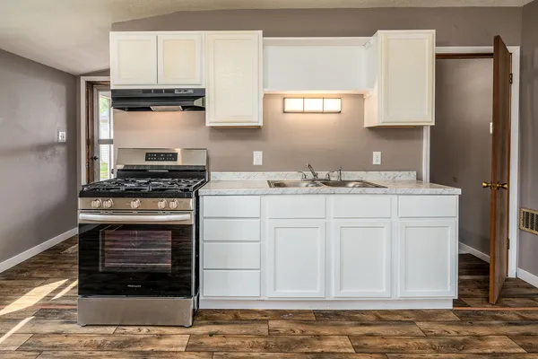 wooden floor in an empty room with a window and wooden floor