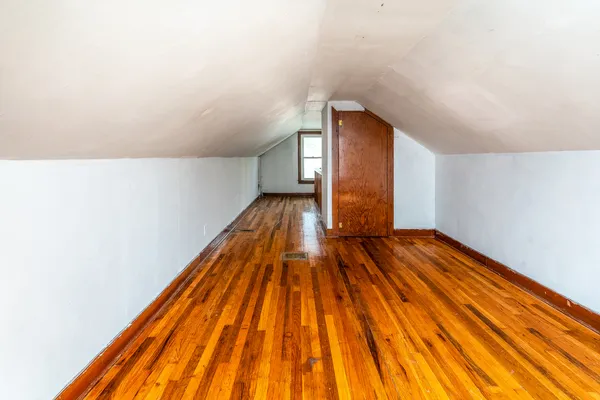 a view of a hallway with wooden walls