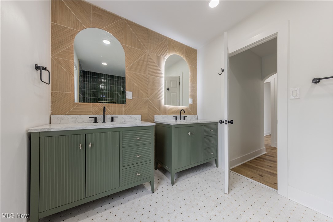 3694 Chelton Road Cleveland, OH 44120 - Photo 26 of 33 Bathroom featuring a sink, two vanities, baseboards, and tile walls