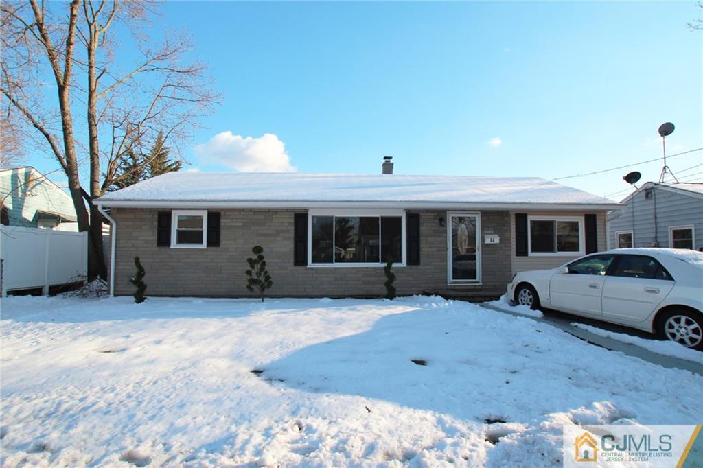 13 Racetrack Road East Brunswick, NJ 08816 - Photo 1 of 15 a front view of a house with a yard