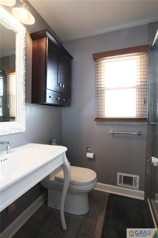 13 Racetrack Road East Brunswick, NJ 08816 - Photo 11 of 15 a bathroom with a sink a toilet and mirror