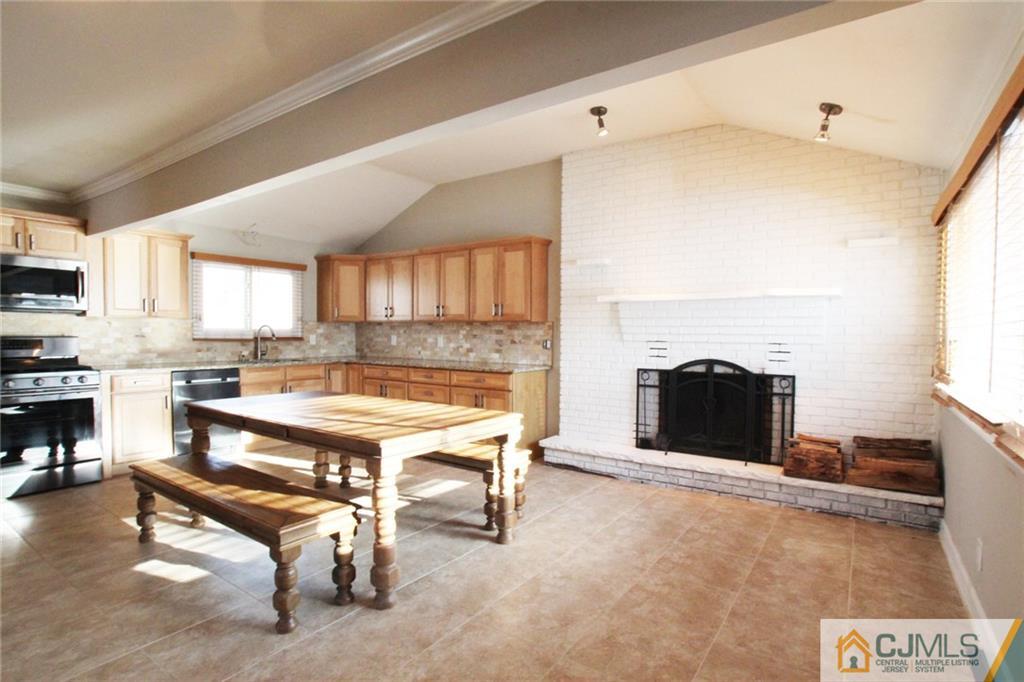 13 Racetrack Road East Brunswick, NJ 08816 - Photo 5 of 15 a living room with furniture a fireplace and a flat screen tv