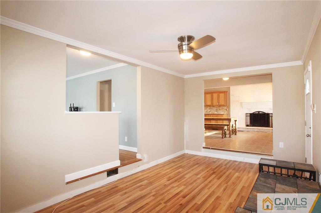 13 Racetrack Road East Brunswick, NJ 08816 - Photo 6 of 15 a bedroom with a bed and wooden floor