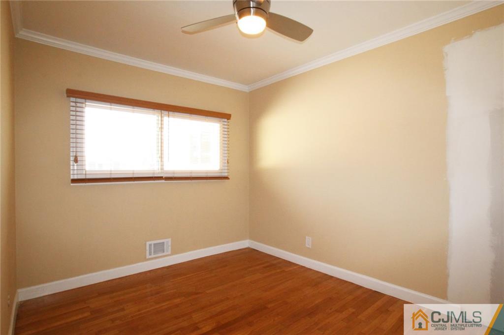 13 Racetrack Road East Brunswick, NJ 08816 - Photo 9 of 15 an empty room with a window