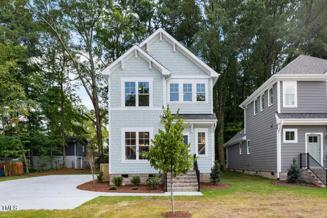 a front view of a house with a yard garage and outdoor seating
