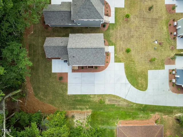 an aerial view of residential house with pool and yard