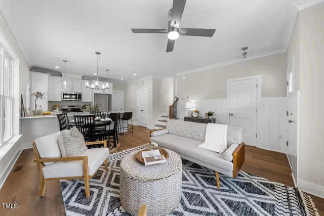 a living room with furniture and kitchen view
