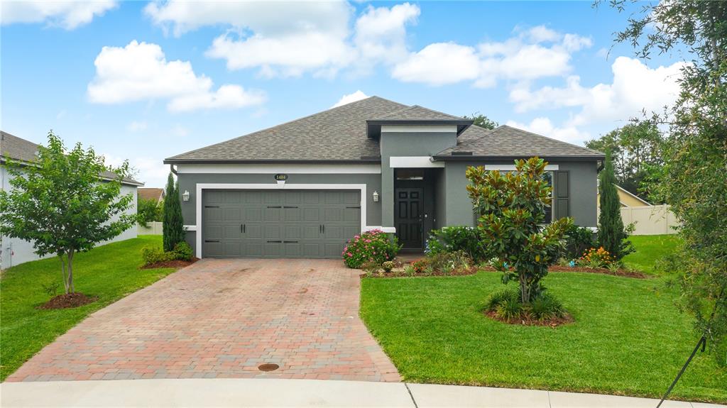 a front view of a house with a yard and garage