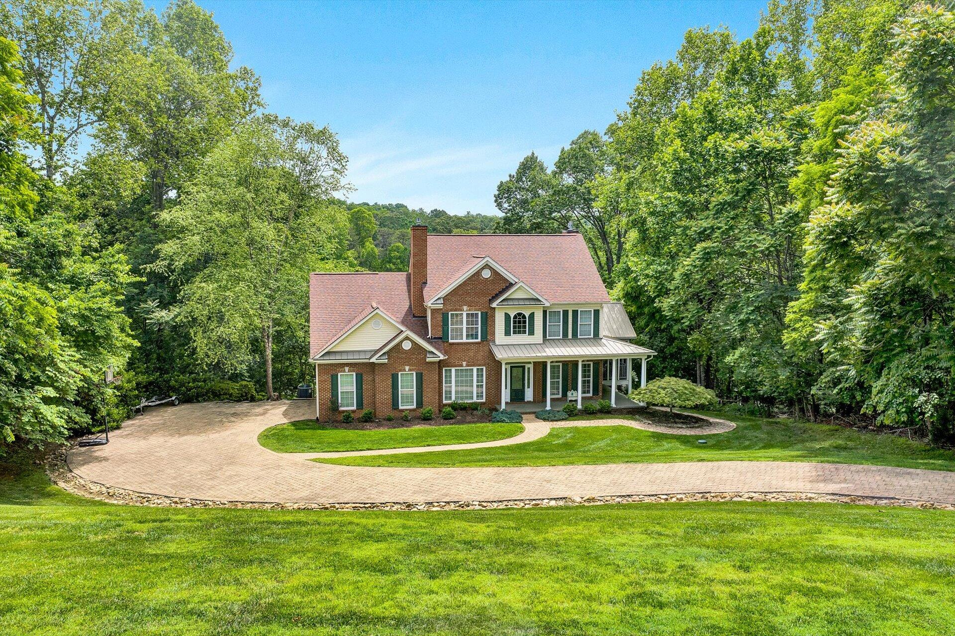 155 Cedar Bay Road Union Hall, VA 24176 - Photo 2 of 61 a view of a white house with a big yard and potted plants and large trees