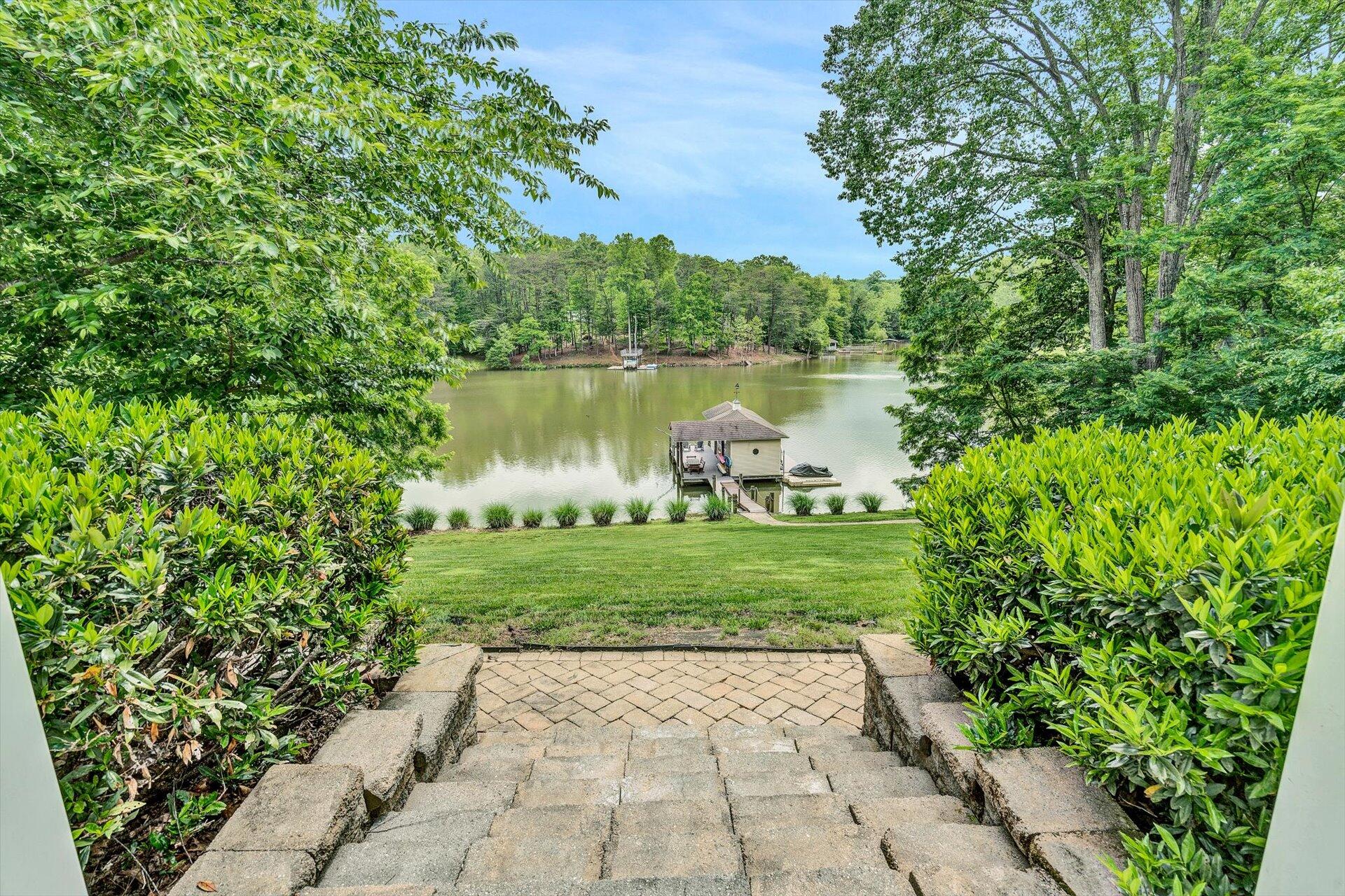 155 Cedar Bay Road Union Hall, VA 24176 - Photo 45 of 61 a view of a lake with a yard and potted plants