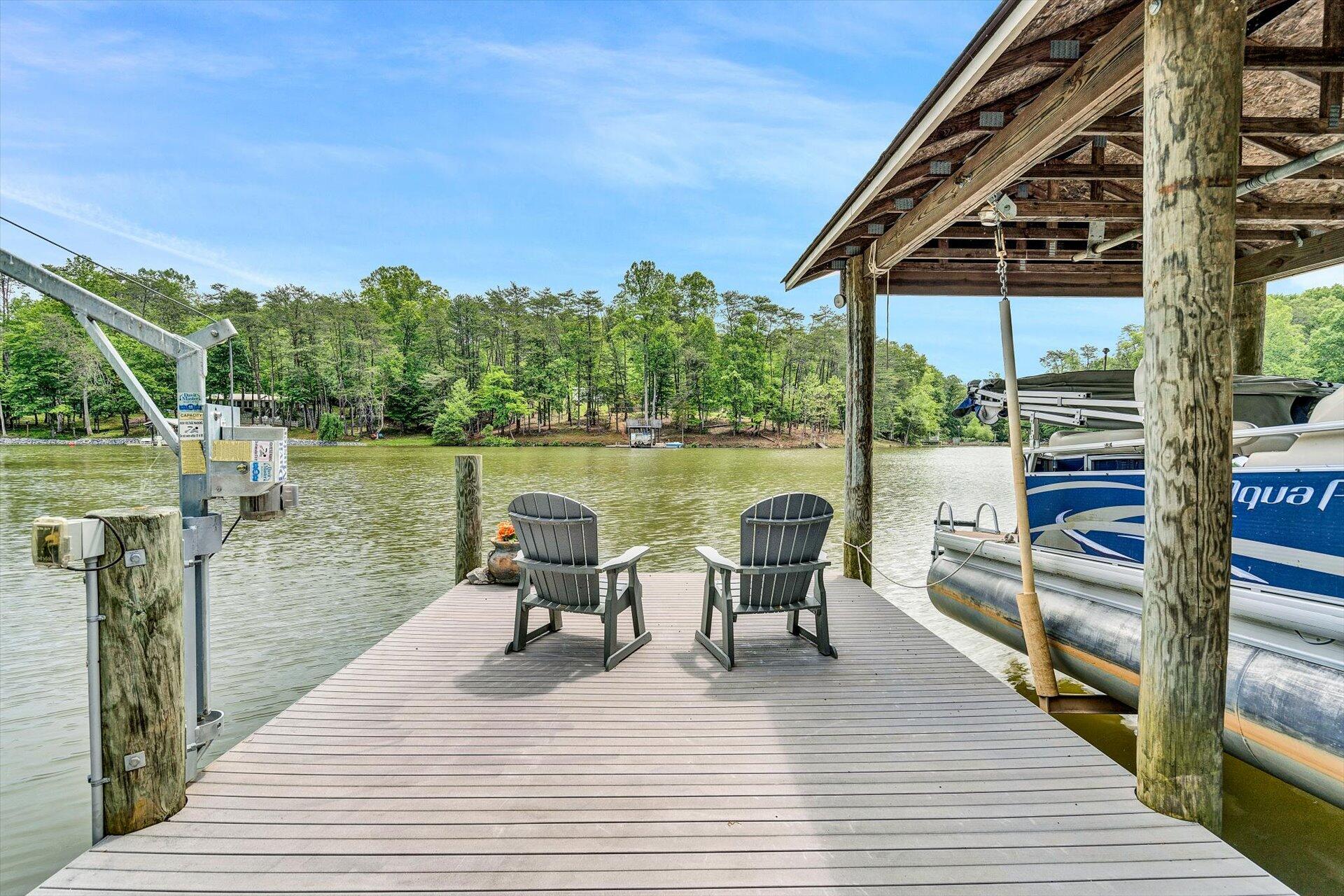 155 Cedar Bay Road Union Hall, VA 24176 - Photo 50 of 61 a view of a lake with couches and wooden floor