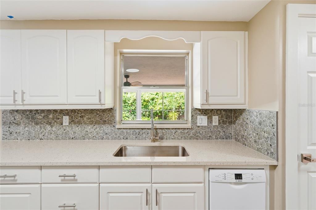 5984 Diana Road Venice, FL 34293 - Photo 13 of 36 a kitchen with a sink and cabinets