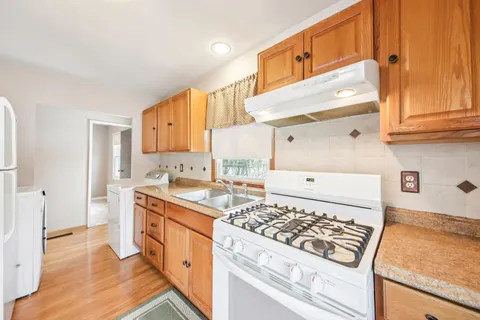 a kitchen with a stove a sink and a refrigerator