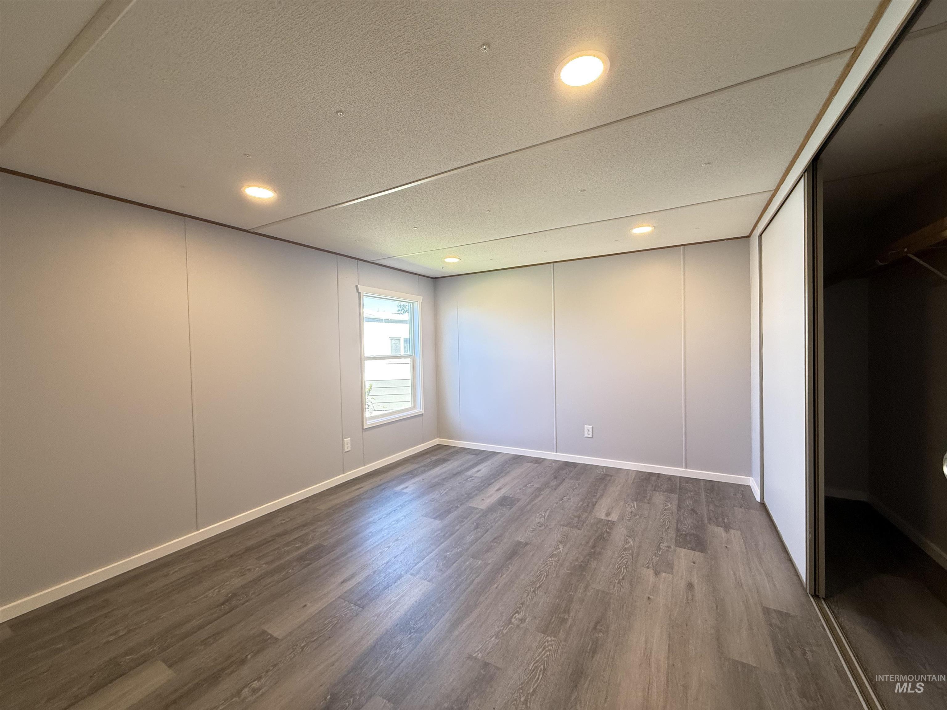 2015 6th Avenue, Unit 321 Clarkston, WA 99403 - Photo 19 of 34 Unfurnished bedroom featuring a decorative wall, dark wood-type flooring, and recessed lighting