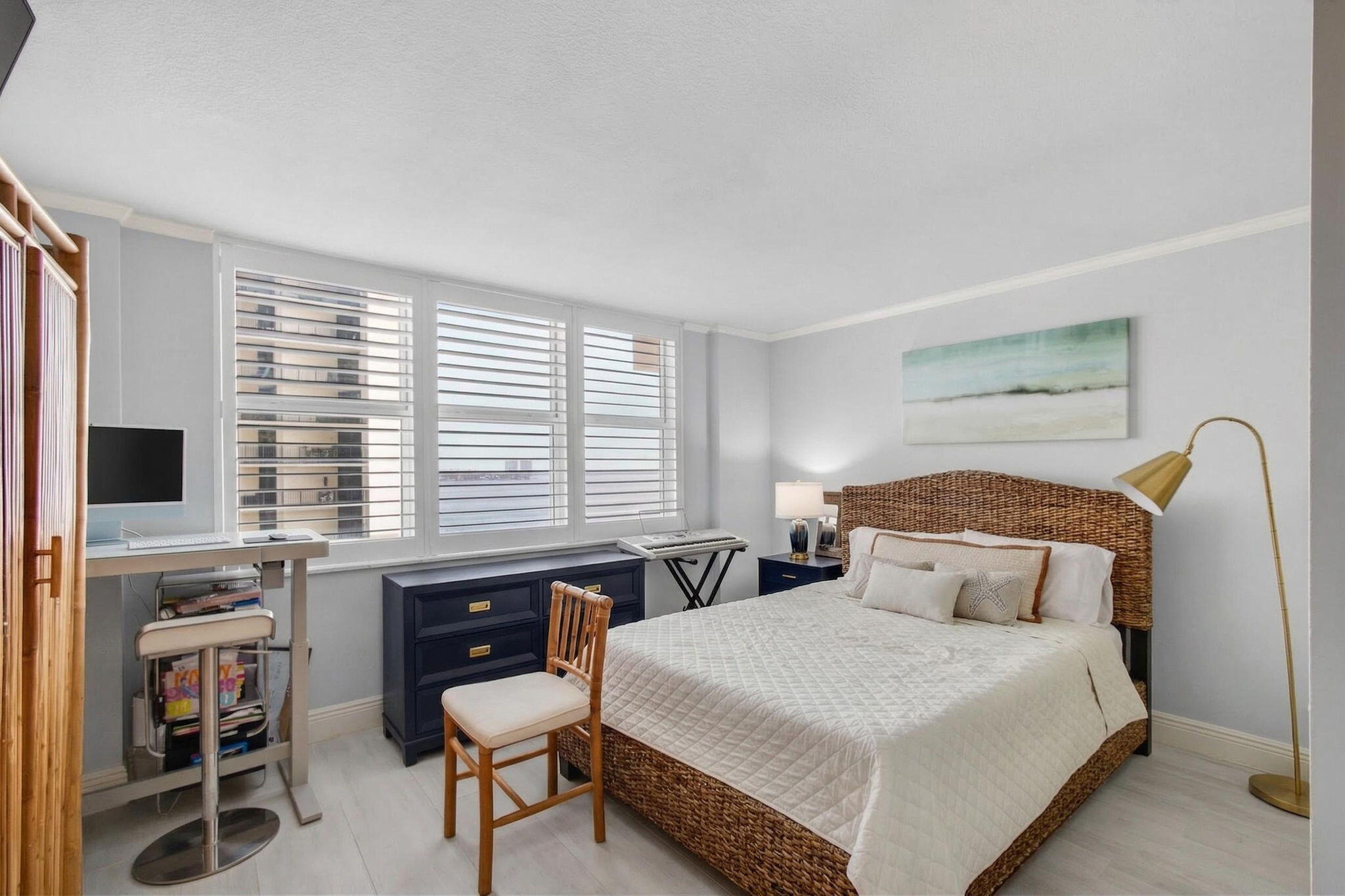 5440 North Ocean Drive, Unit 805 Singer Island, FL 33404 - Photo 11 of 56 a bedroom with a bed and a flat screen tv
