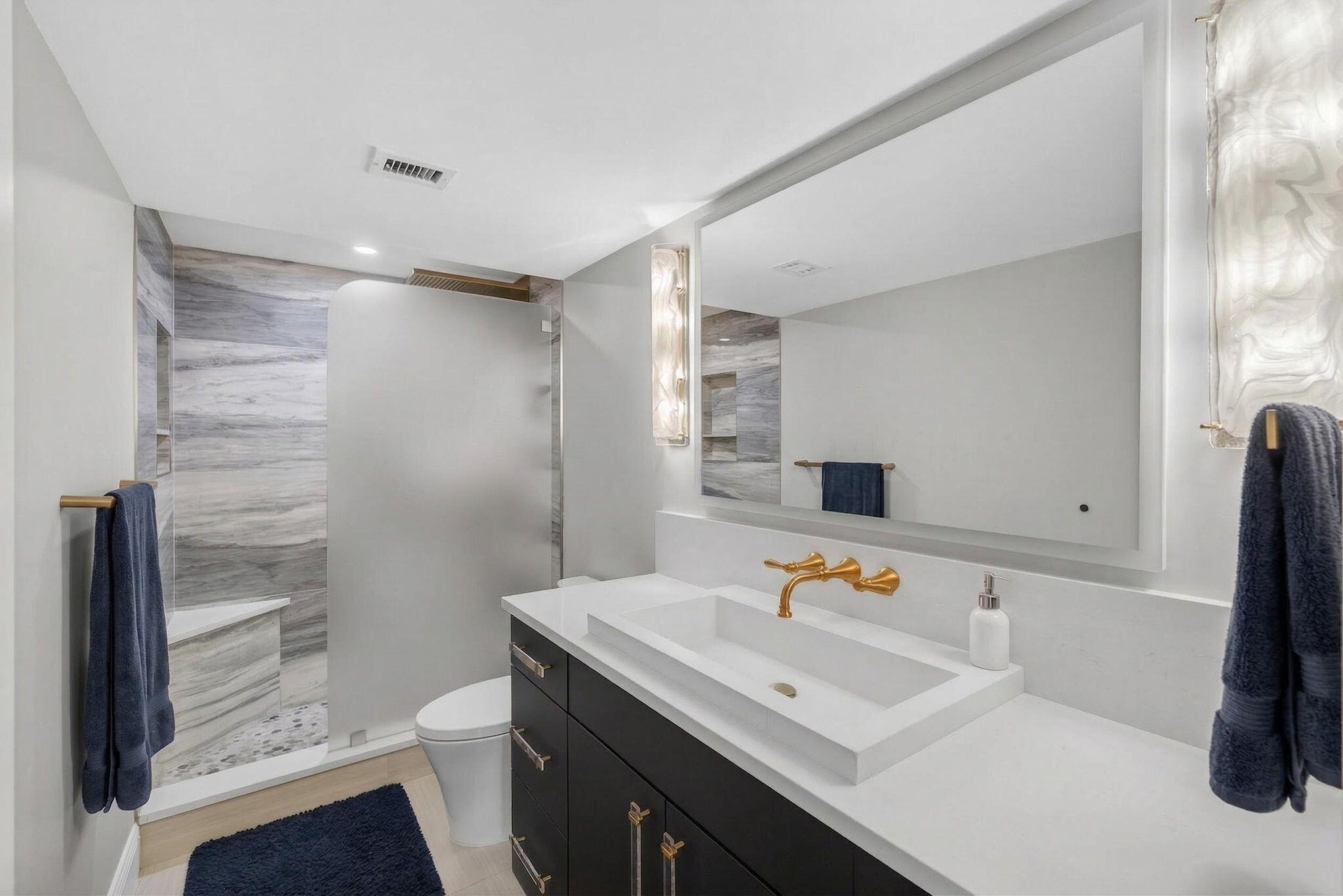 5440 North Ocean Drive, Unit 805 Singer Island, FL 33404 - Photo 13 of 56 a bathroom with a sink toilet and shower