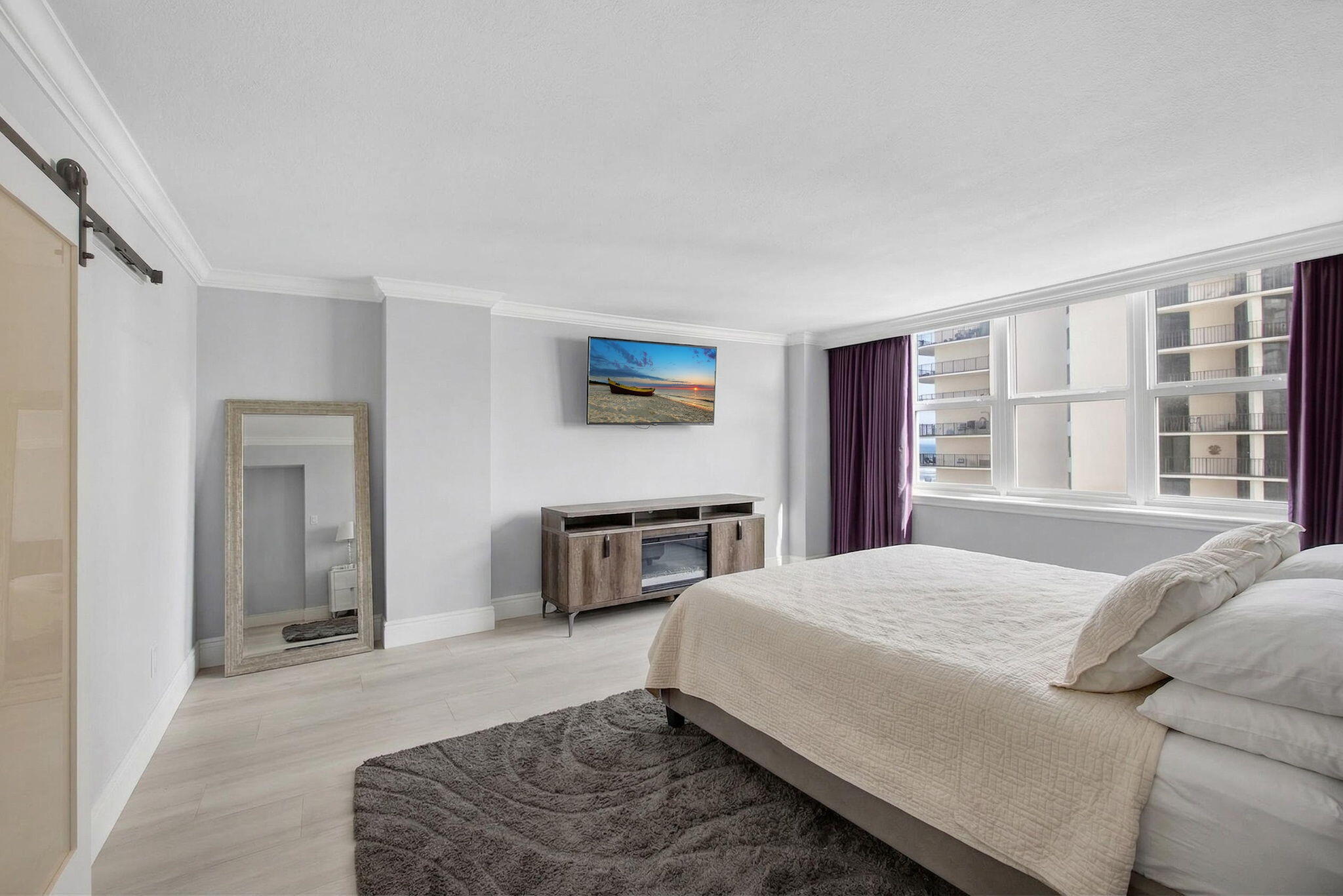 5440 North Ocean Drive, Unit 805 Singer Island, FL 33404 - Photo 15 of 56 a spacious bedroom with a bed a dresser and a large window