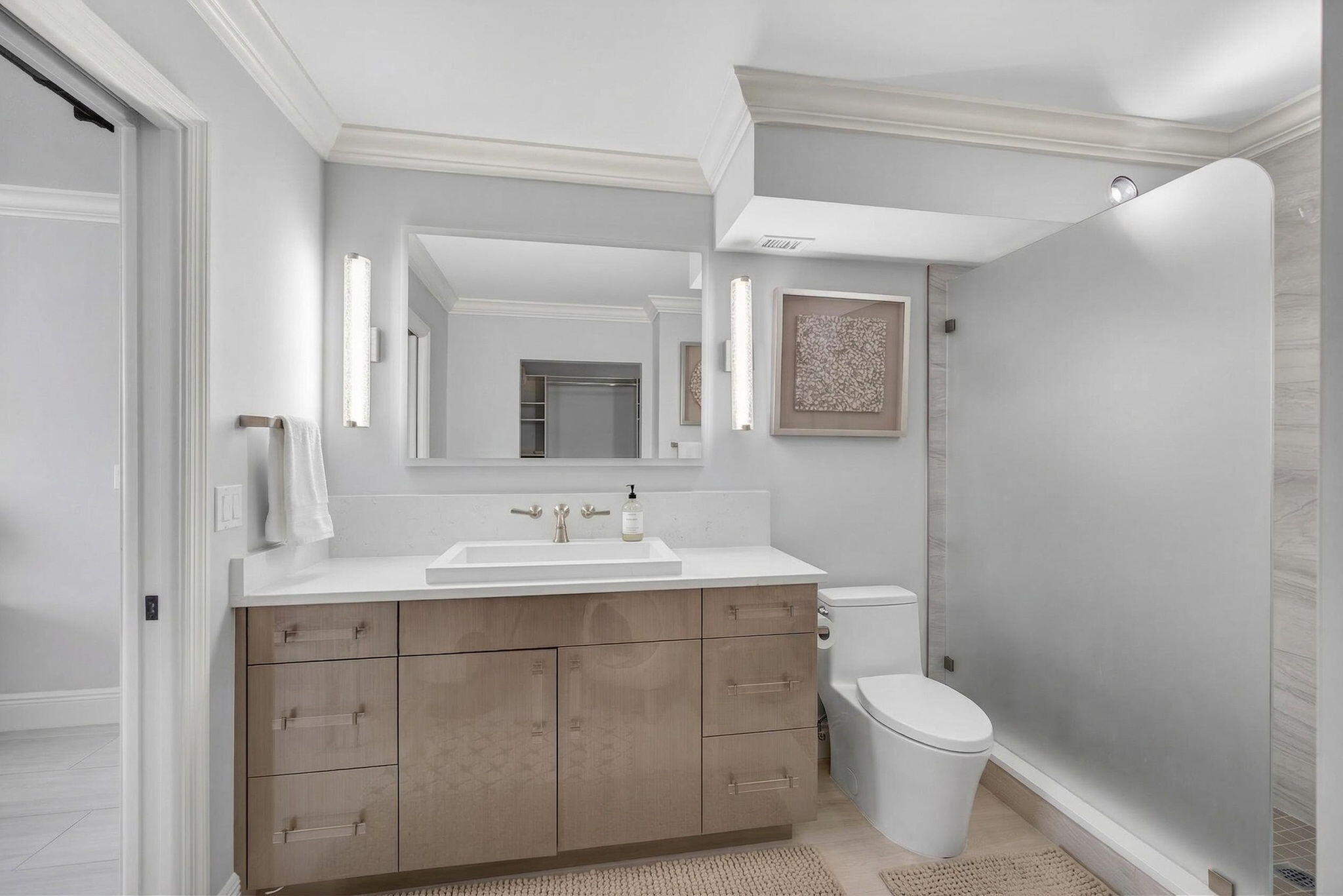 5440 North Ocean Drive, Unit 805 Singer Island, FL 33404 - Photo 19 of 56 a bathroom with a toilet a sink and mirror