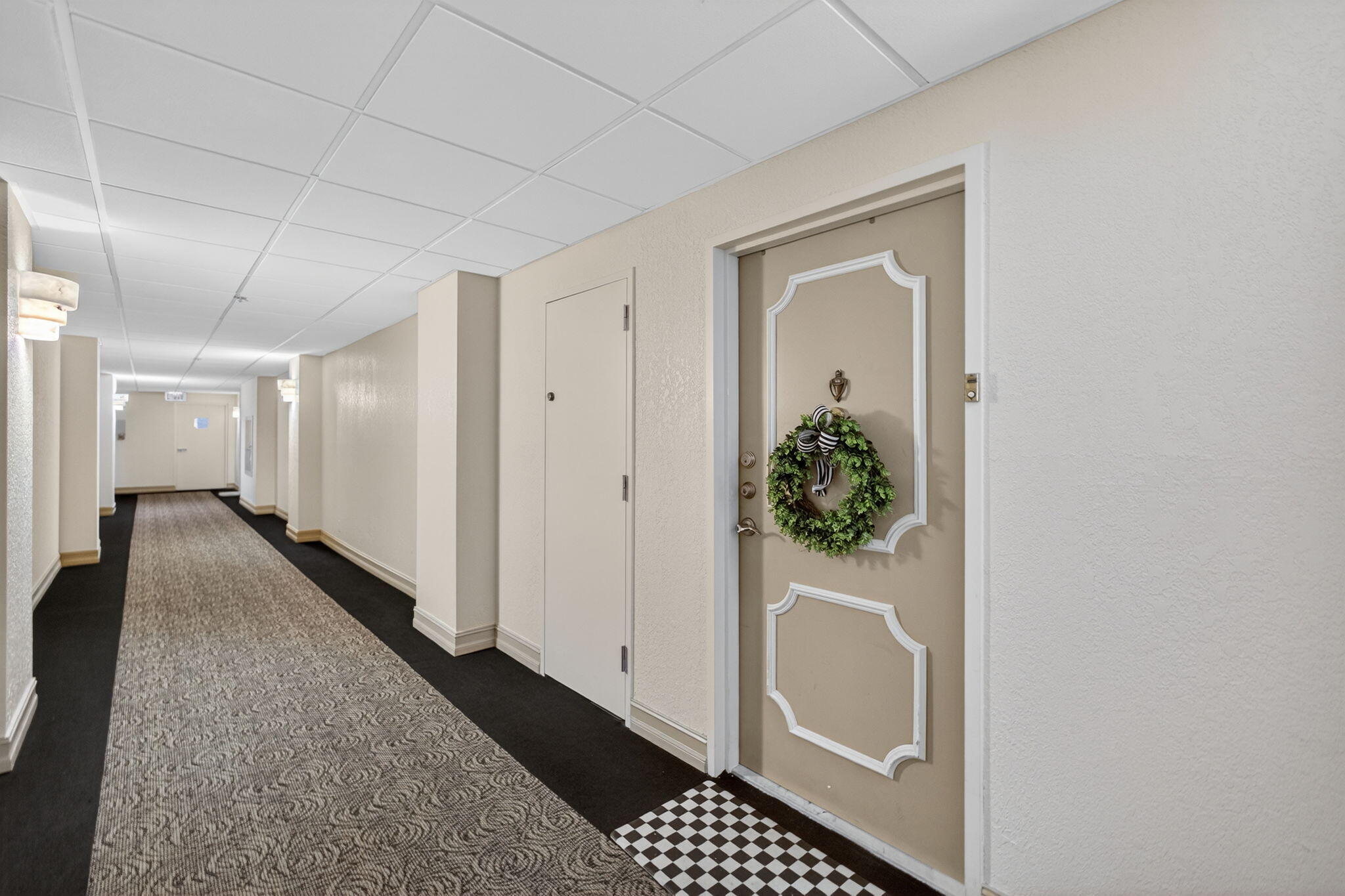 5440 North Ocean Drive, Unit 805 Singer Island, FL 33404 - Photo 25 of 56 a view of a hallway with wooden floor and a bathroom