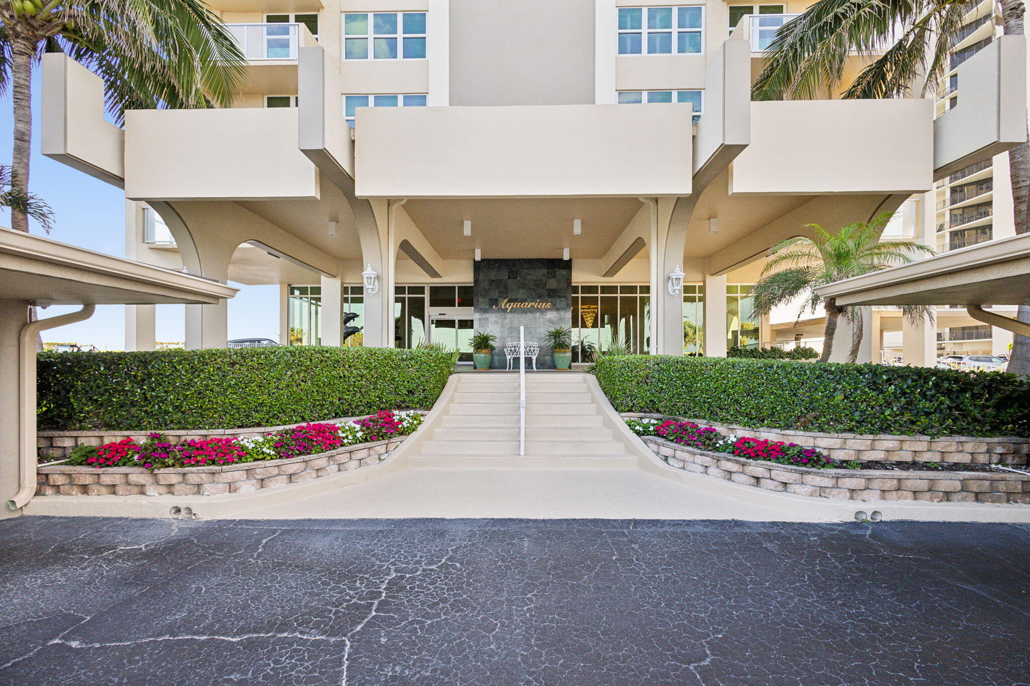 5440 North Ocean Drive, Unit 805 Singer Island, FL 33404 - Photo 26 of 56 front view of a house with a small yard and palm trees