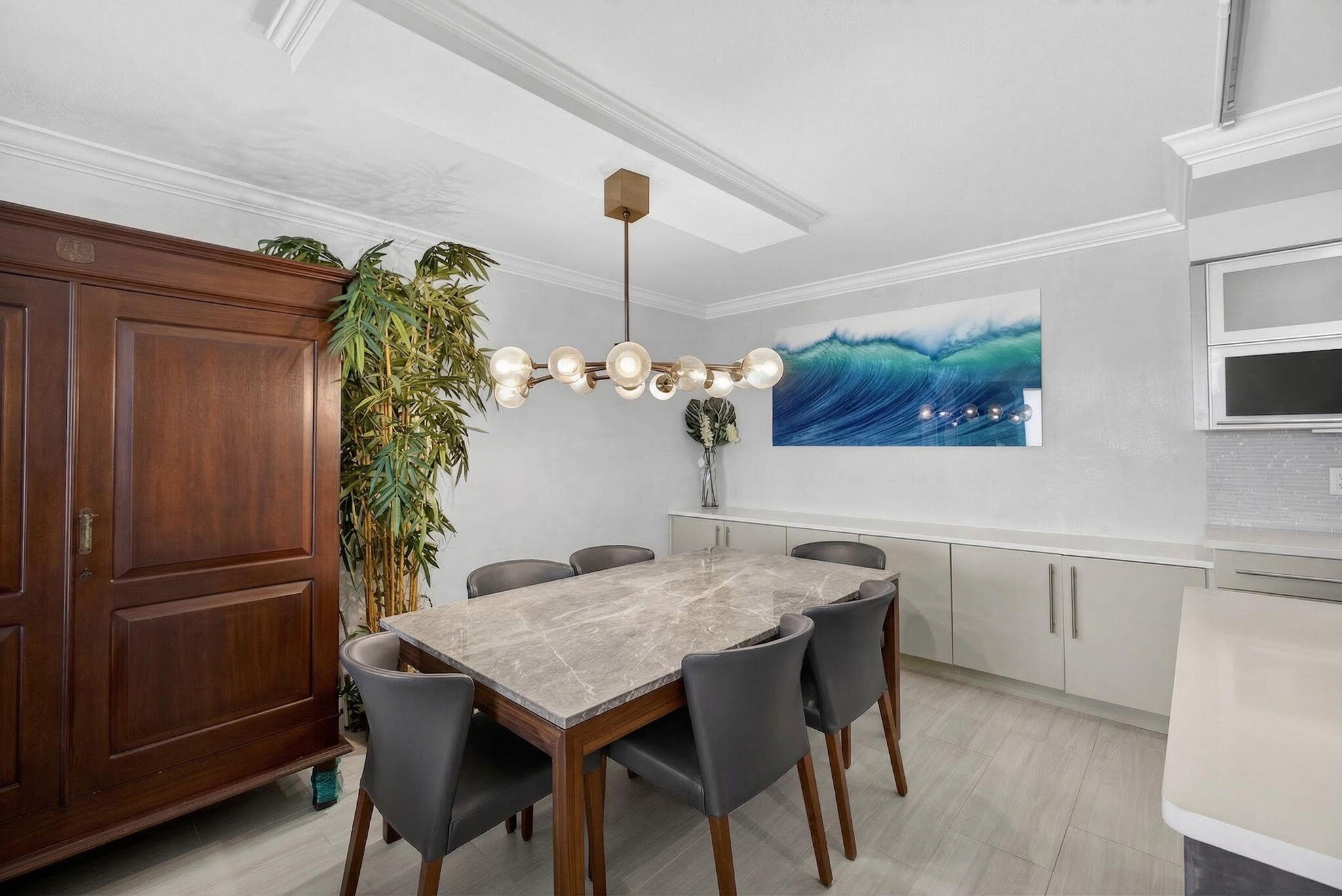 5440 North Ocean Drive, Unit 805 Singer Island, FL 33404 - Photo 3 of 56 a view of a dining table chairs and chandelier