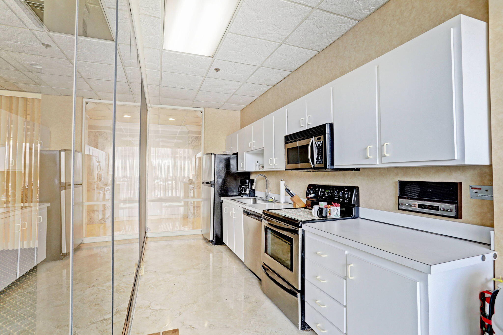 5440 North Ocean Drive, Unit 805 Singer Island, FL 33404 - Photo 40 of 56 a kitchen with stainless steel appliances granite countertop a stove a sink and a refrigerator