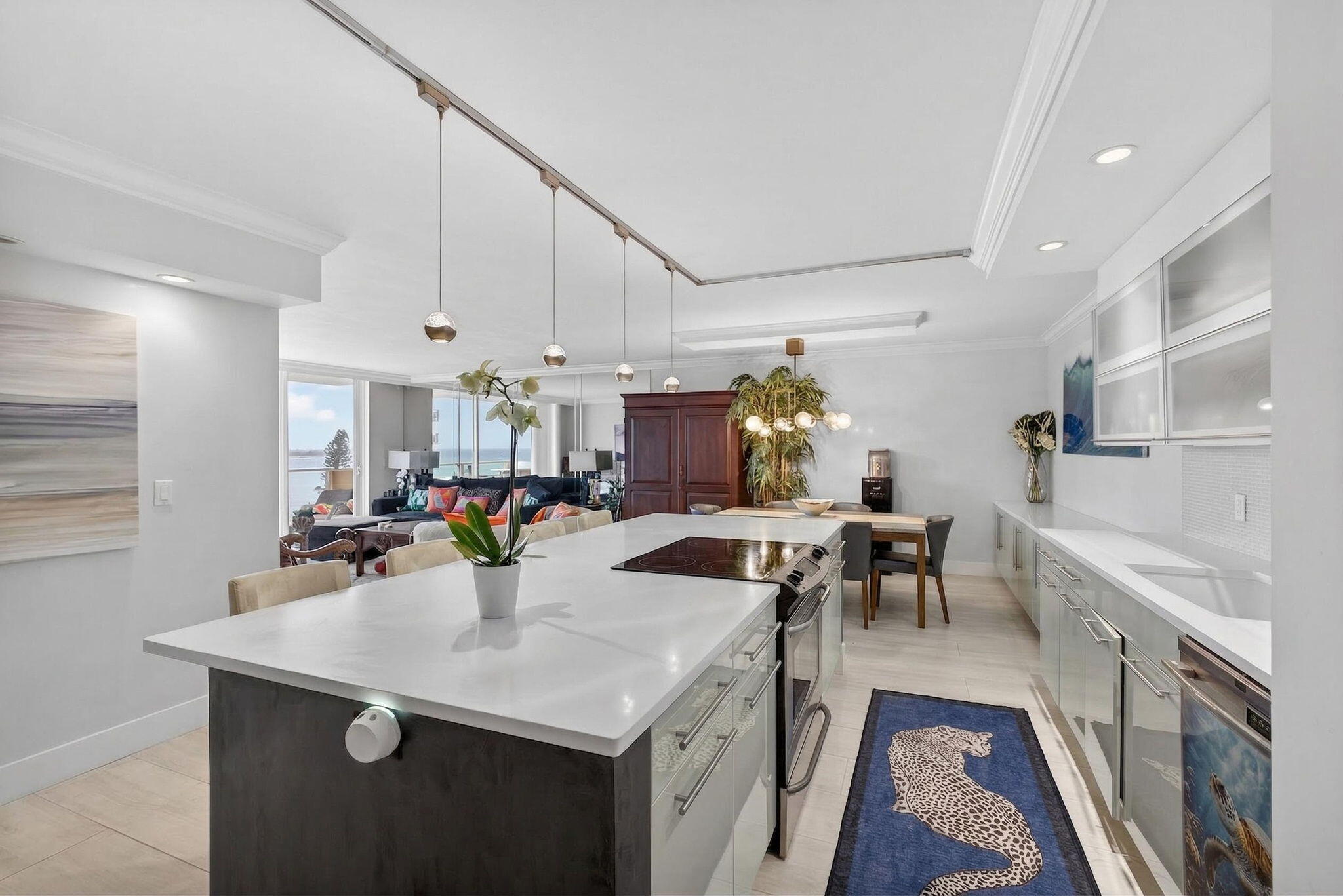 5440 North Ocean Drive, Unit 805 Singer Island, FL 33404 - Photo 5 of 56 a kitchen with stainless steel appliances a sink a counter top space and living room view