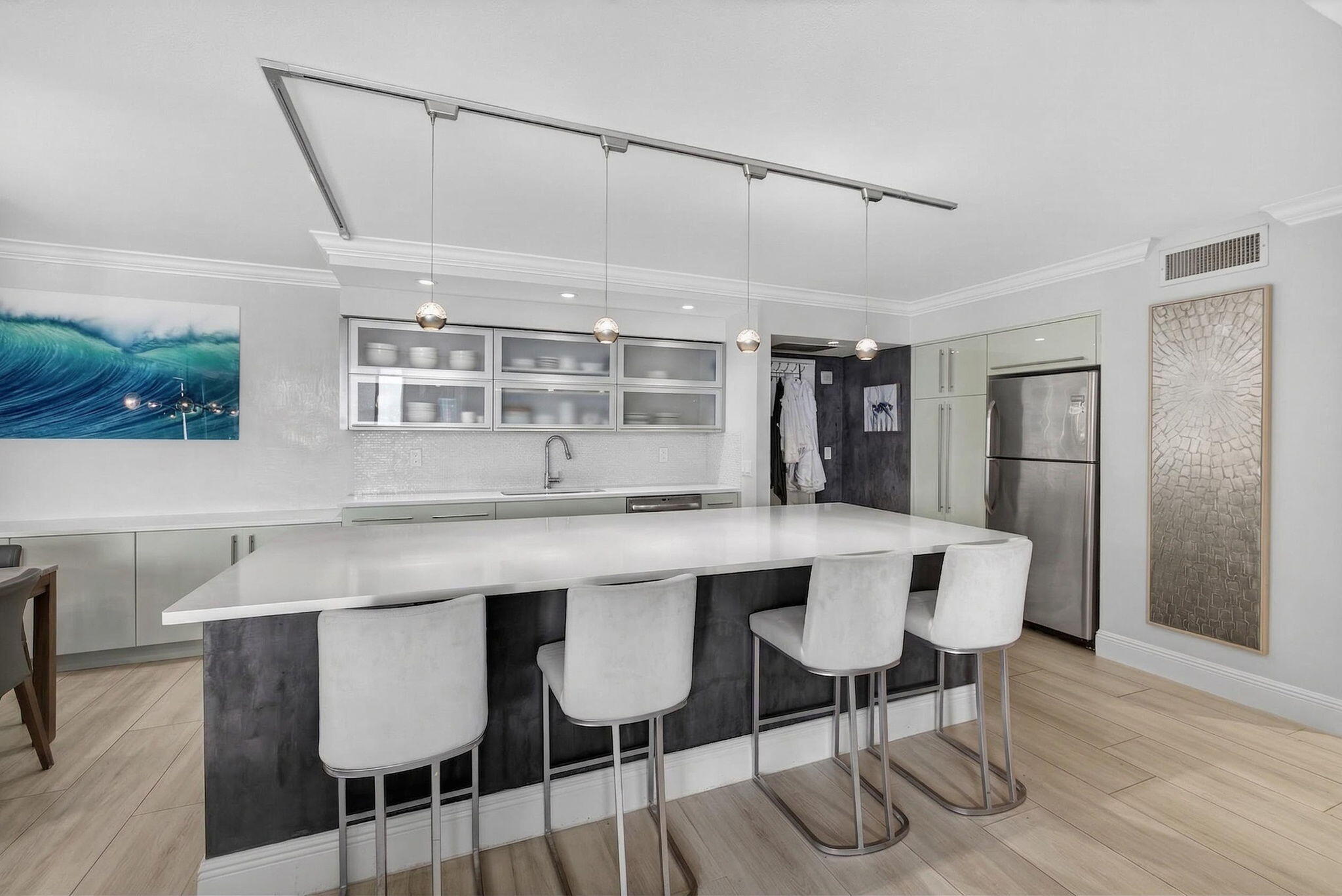 5440 North Ocean Drive, Unit 805 Singer Island, FL 33404 - Photo 7 of 56 a kitchen with a dining table chairs and wooden floor