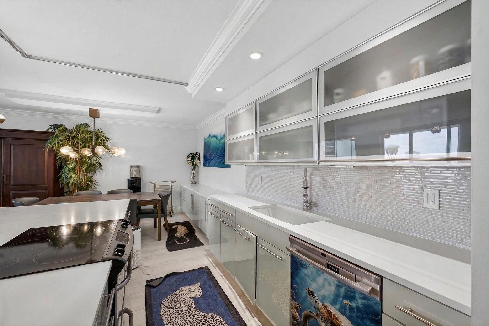 5440 North Ocean Drive, Unit 805 Singer Island, FL 33404 - Photo 9 of 56 a kitchen with a sink and a stove top oven