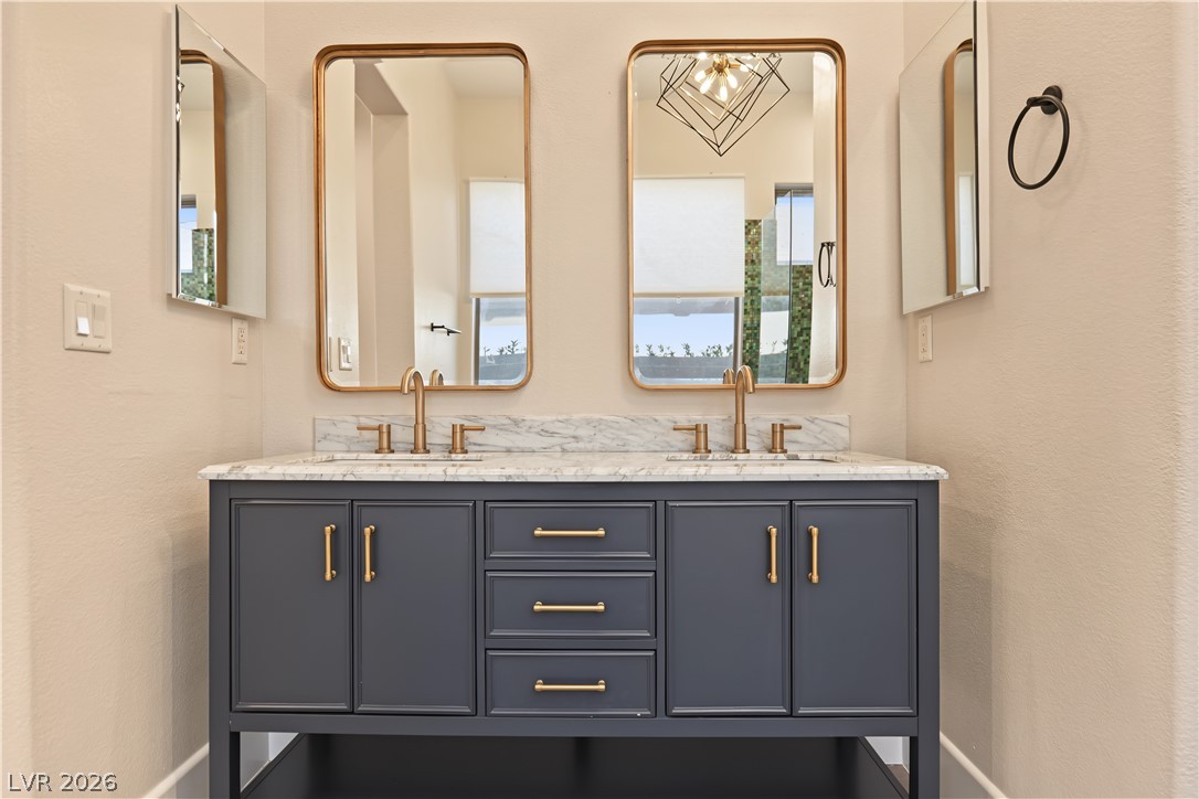 6 Mohansic Road Henderson, NV 89052 - Photo 26 of 38 A refined dual vanity with marble countertops serves as the centerpiece of this bathroom.