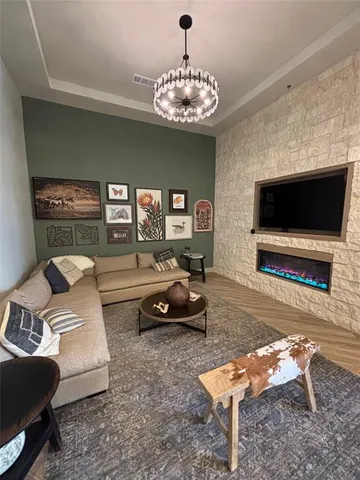 a living room with lots of furniture and a wooden floor