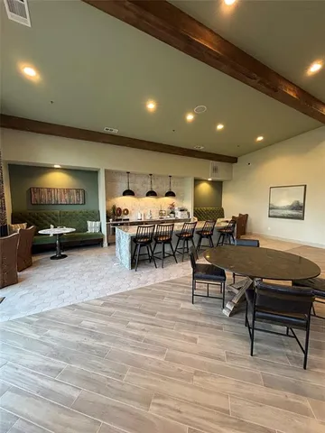 a living room with furniture a flat screen tv and kitchen view