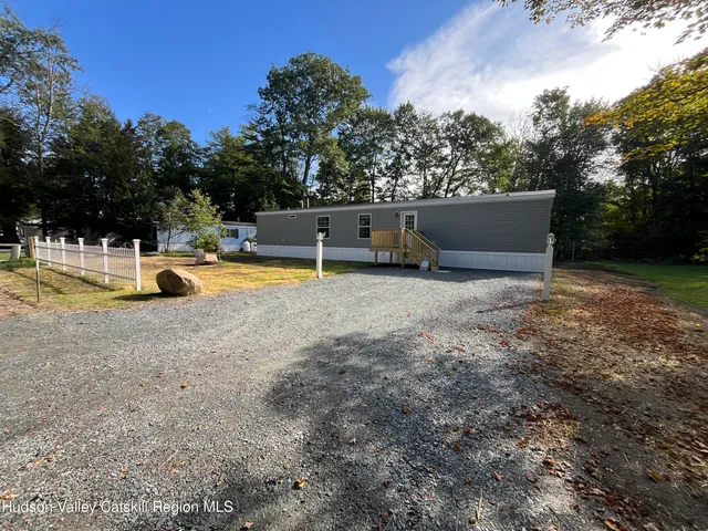 a view of a house with swimming pool and sitting area