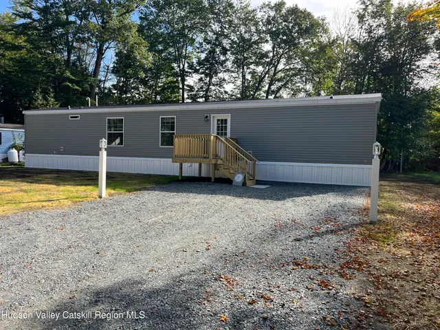 a view of a chairs and table in the backyard
