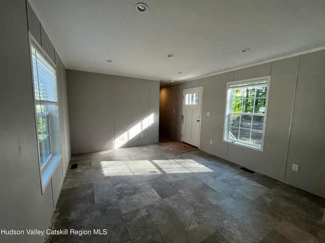 a view of livingroom with an empty space and window