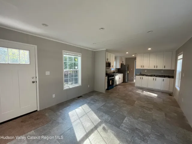 a kitchen with stainless steel appliances a stove sink microwave and cabinets