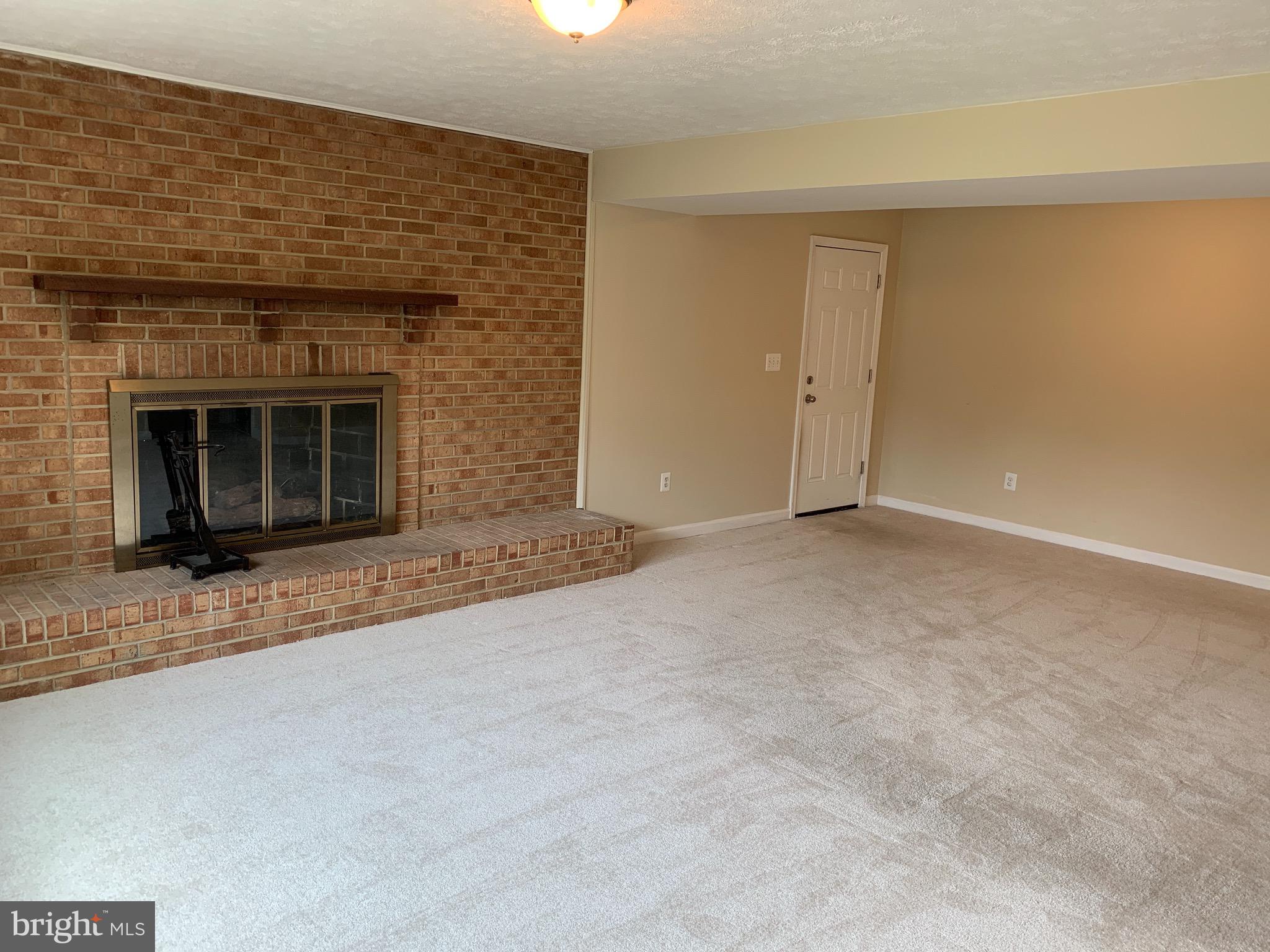 9700 Brookford Road Potomac, MD 20854 - Photo 24 of 27 a view of an empty room with a fireplace