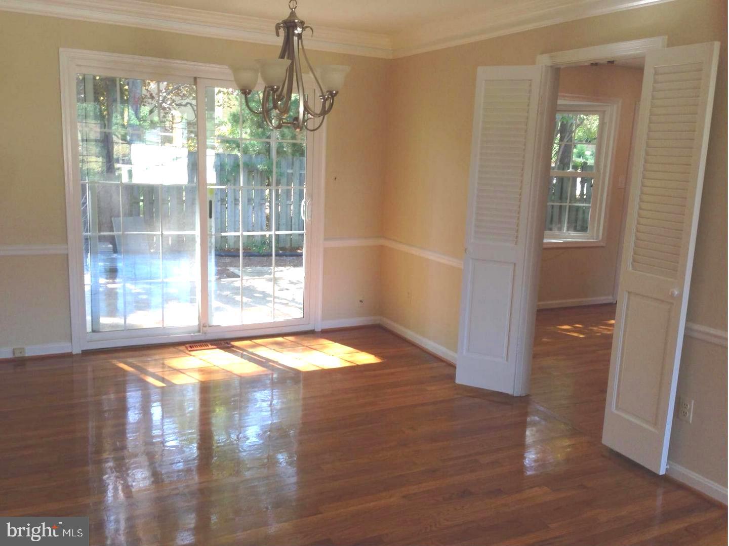 9700 Brookford Road Potomac, MD 20854 - Photo 4 of 27 a view of empty room with wooden floor and fan