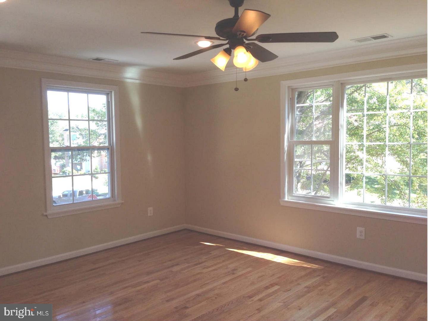 9700 Brookford Road Potomac, MD 20854 - Photo 6 of 27 a view of an empty room with wooden floor and window
