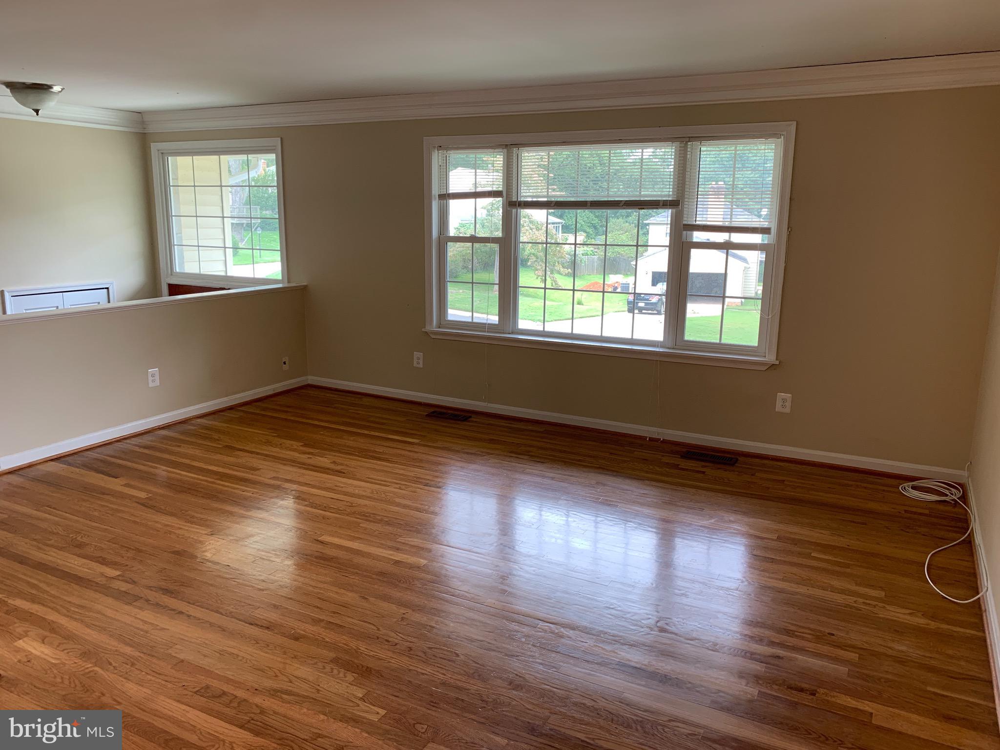 9700 Brookford Road Potomac, MD 20854 - Photo 7 of 27 a view of an empty room with wooden floor and a window