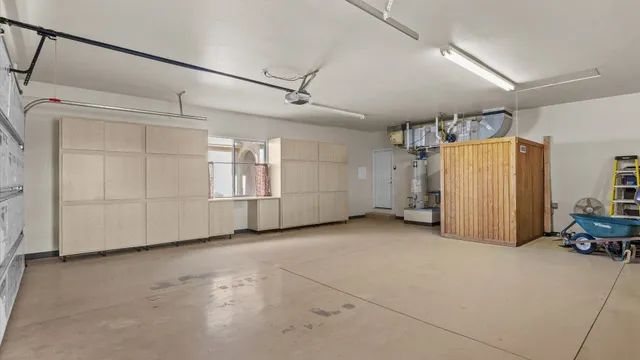 a view of a livingroom with furniture and a refrigerator
