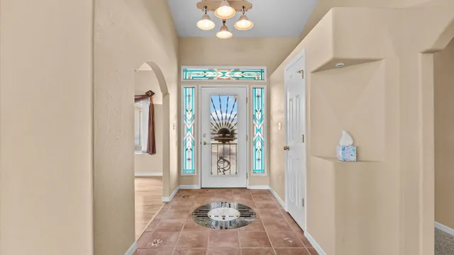 a view of a hallway to a livingroom with furniture