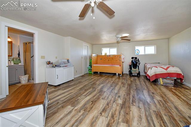 20480 Enoch Road Colorado Springs, CO 80928 - Photo 21 of 45 Bedroom featuring ensuite bathroom, dark wood-type flooring, and ceiling fan