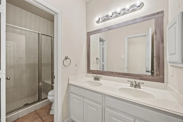 a bathroom with a bathtub a shower a sink and mirror