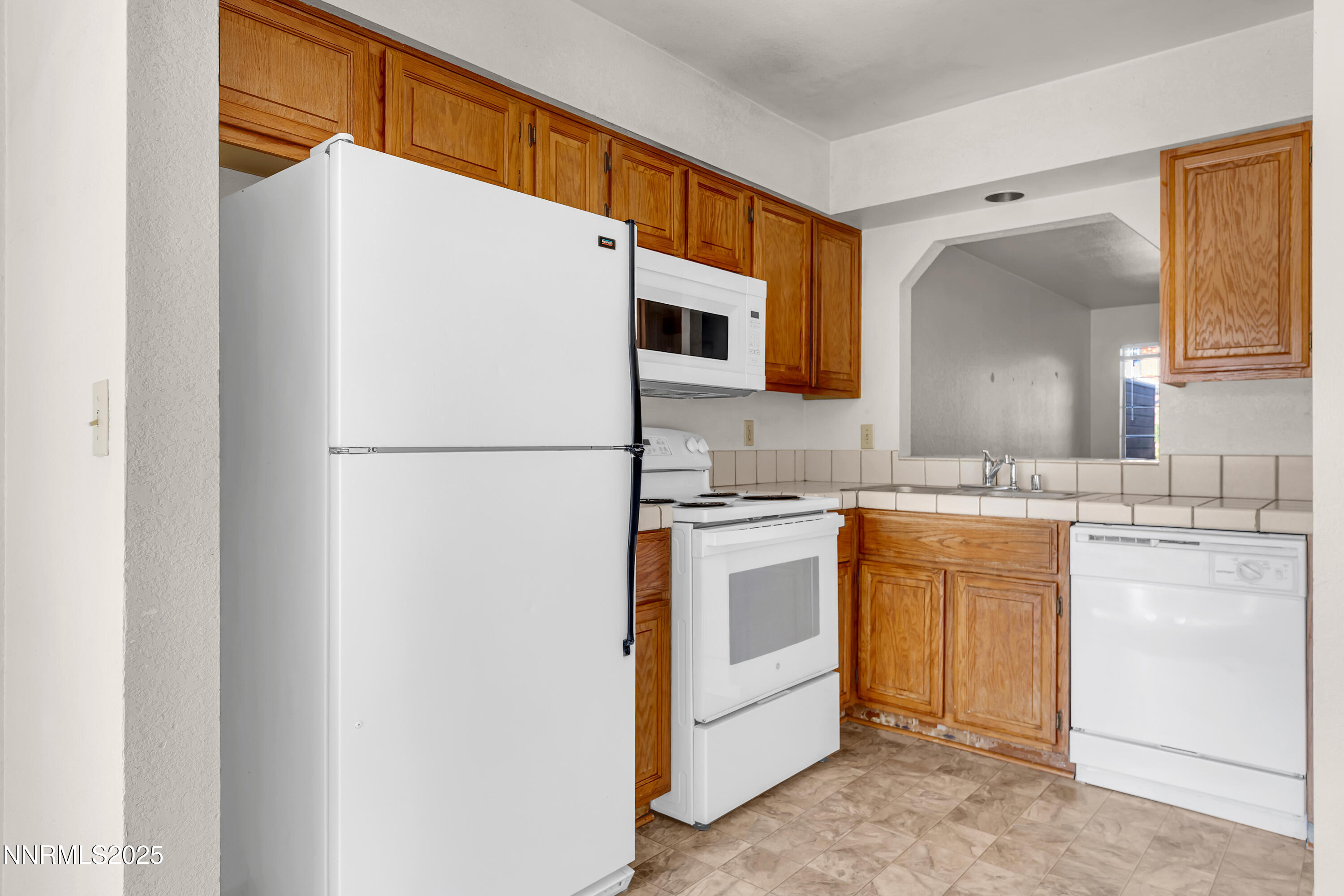 2650 Plumas Street, Unit 11 Reno, NV 89509 - Photo 11 of 33 a kitchen with stainless steel appliances granite countertop a refrigerator and a sink
