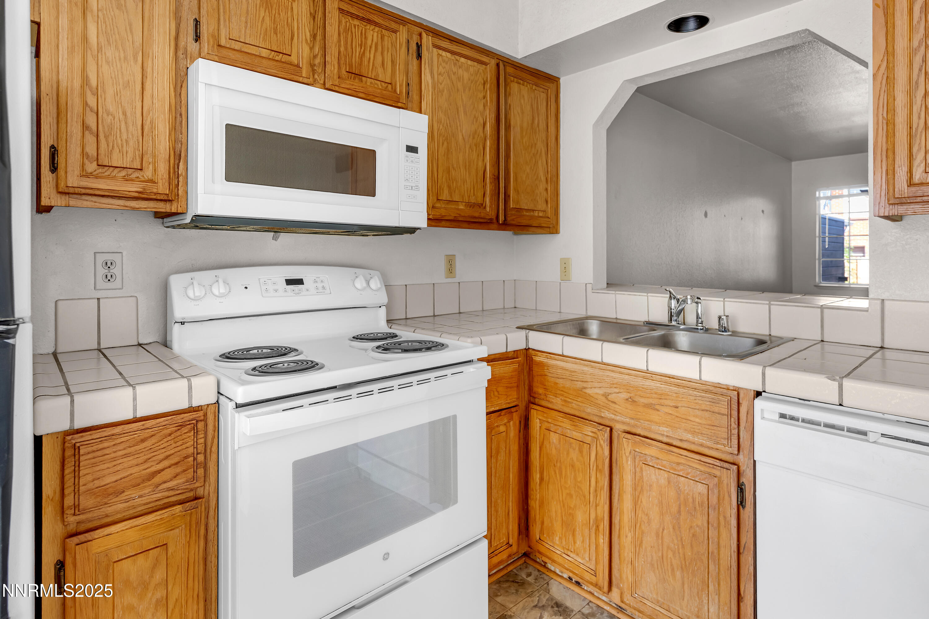 2650 Plumas Street, Unit 11 Reno, NV 89509 - Photo 12 of 33 a kitchen with stainless steel appliances granite countertop a sink stove and microwave
