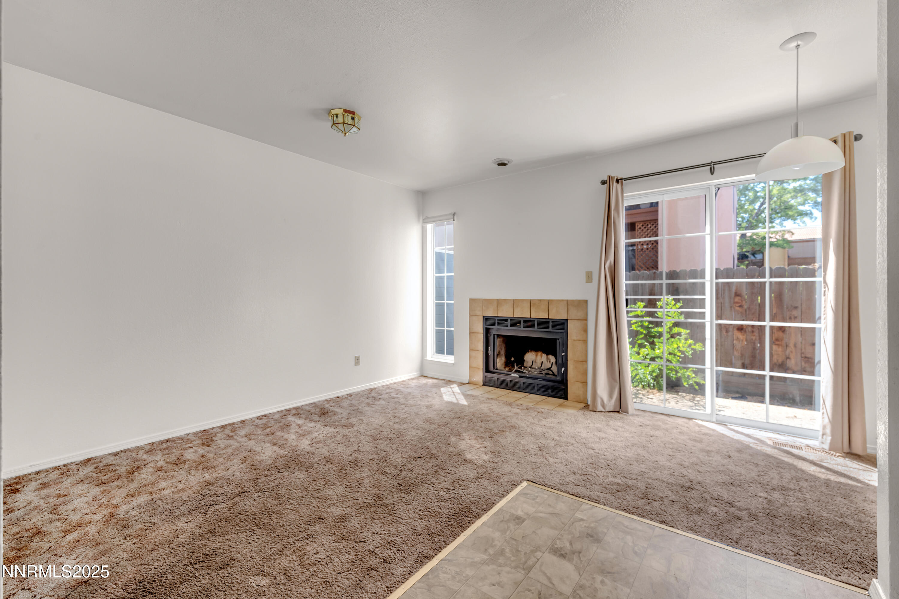 2650 Plumas Street, Unit 11 Reno, NV 89509 - Photo 13 of 33 a view of empty room with a fireplace and window