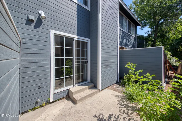 a view of a house with a wooden fence