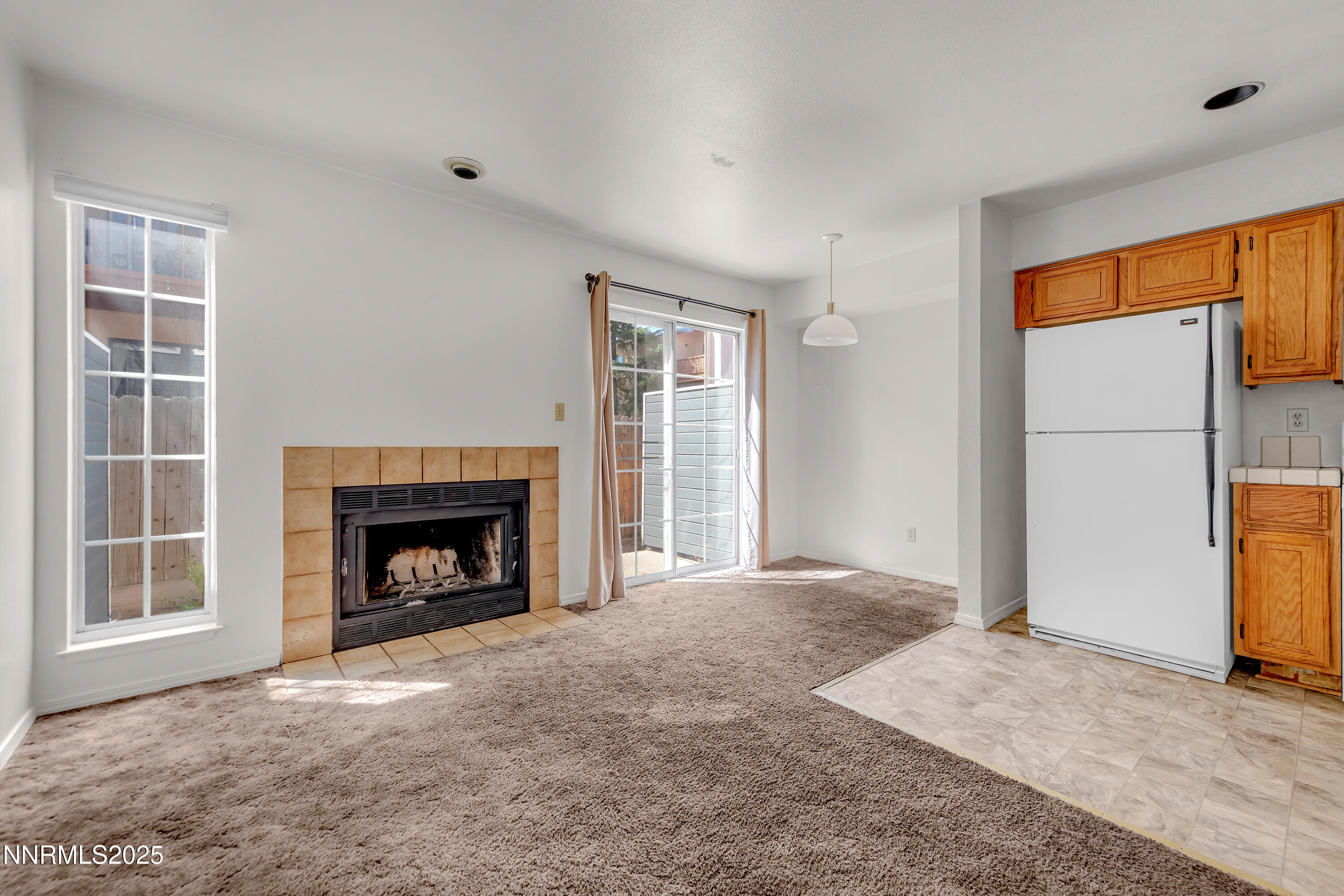 2650 Plumas Street, Unit 11 Reno, NV 89509 - Photo 8 of 33 a view of an empty room with a fireplace and a window